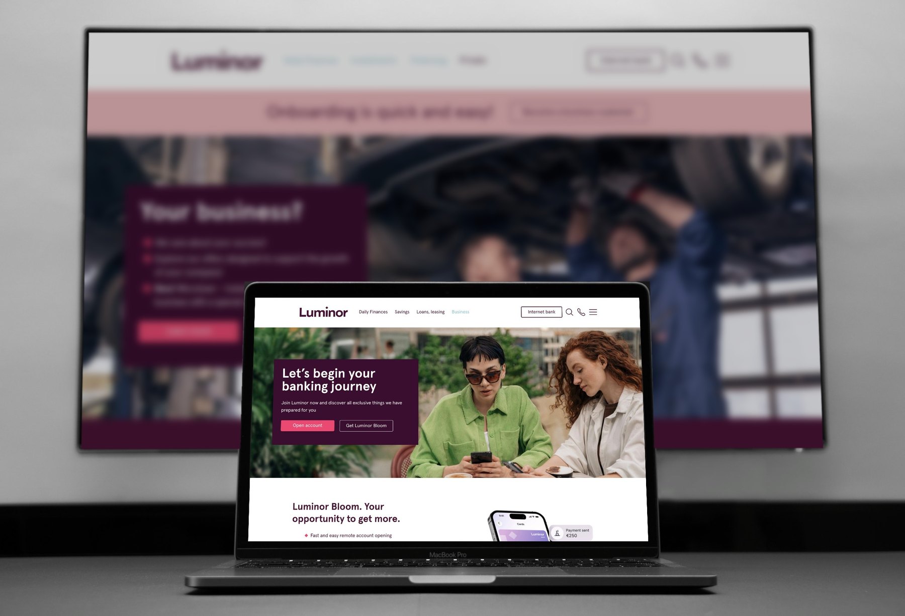 Luminor website on a MacBook Pro, with the Luminor business page blurred on a large screen behind it